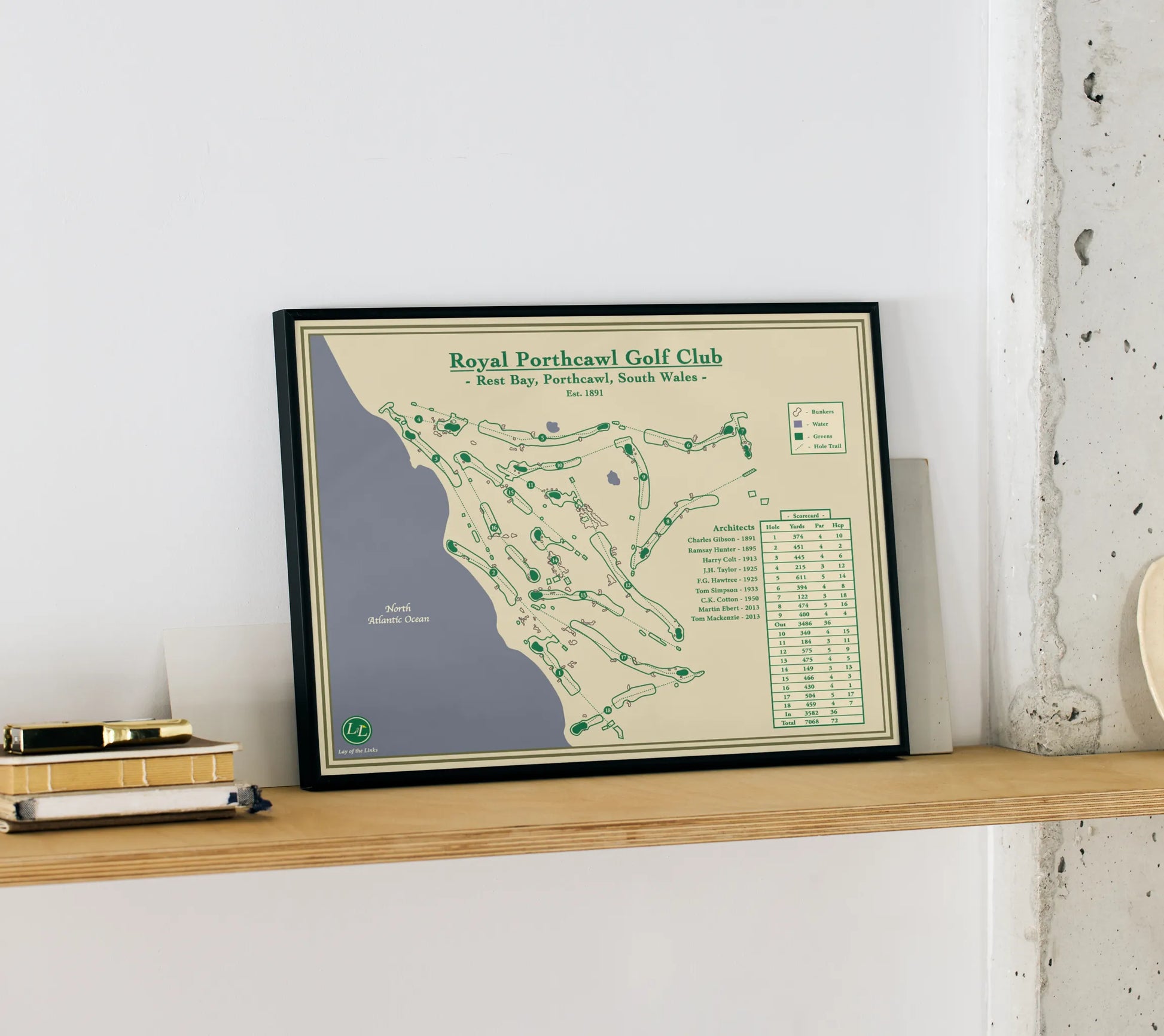 Framed map of Royal Perthawl Golf Club on a wooden shelf against a white wall.