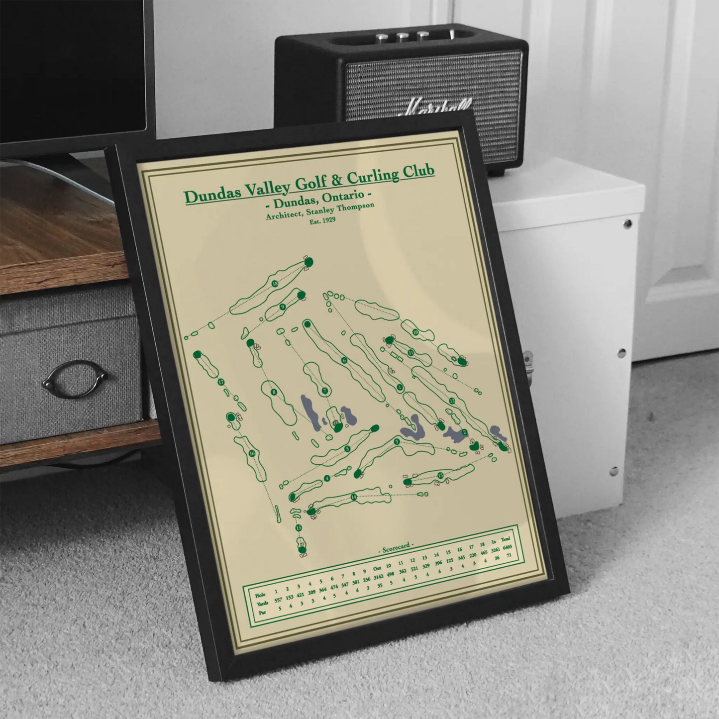 Framed Course map of Dundas Valley Golf & Curling Club on a carpeted floor with a speaker in the background.