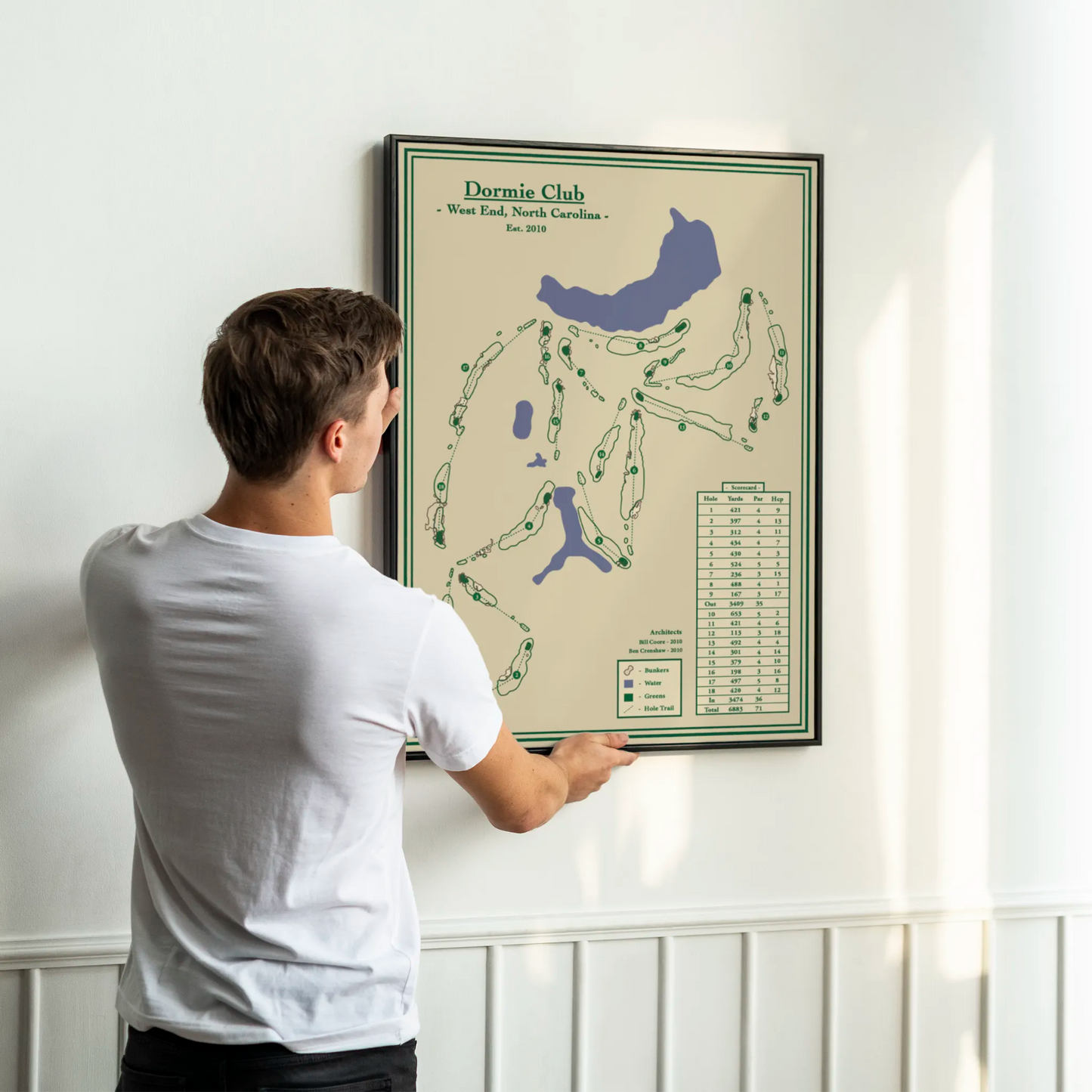 Dormie Club course map print in a black wood frame showing the Coore and Crenshaw design and sweeping elevation changes.
