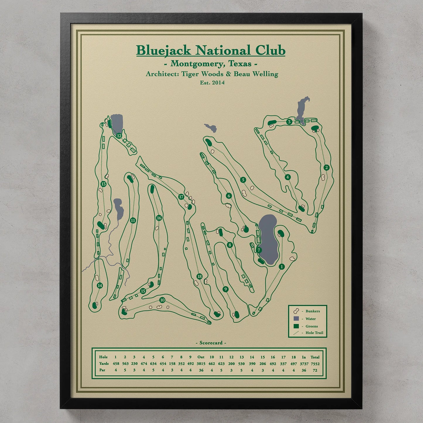 Bluejack National course map in a black wood frame showing the Tiger Woods design winding through towering Texas pines.