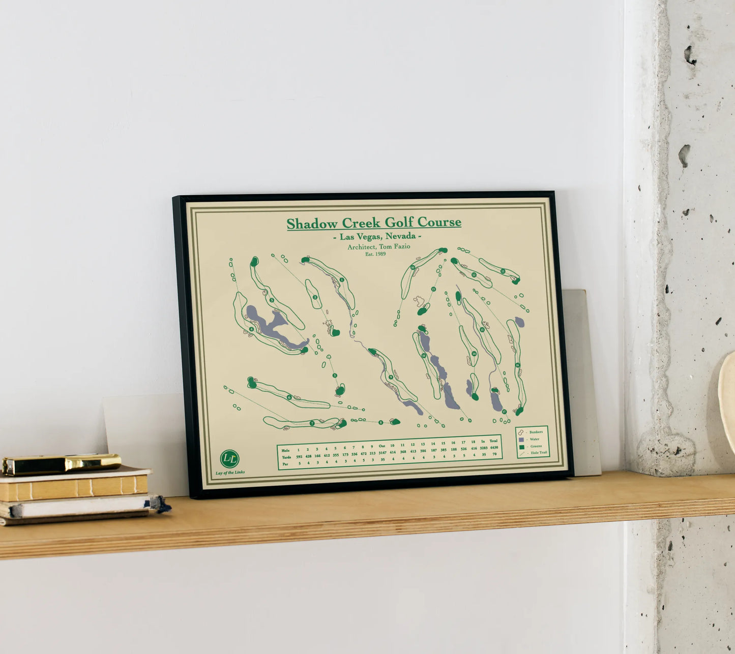 Shadow Creek Golf Course Map Print sitting on a wood shelf 