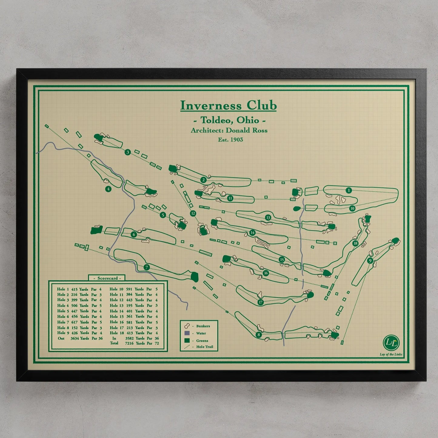 A framed golf course map print for Inverness Club, Toldeo, Ohio, featuring green course layouts and text on a cream background with a black frame, shown against a light gray wall.