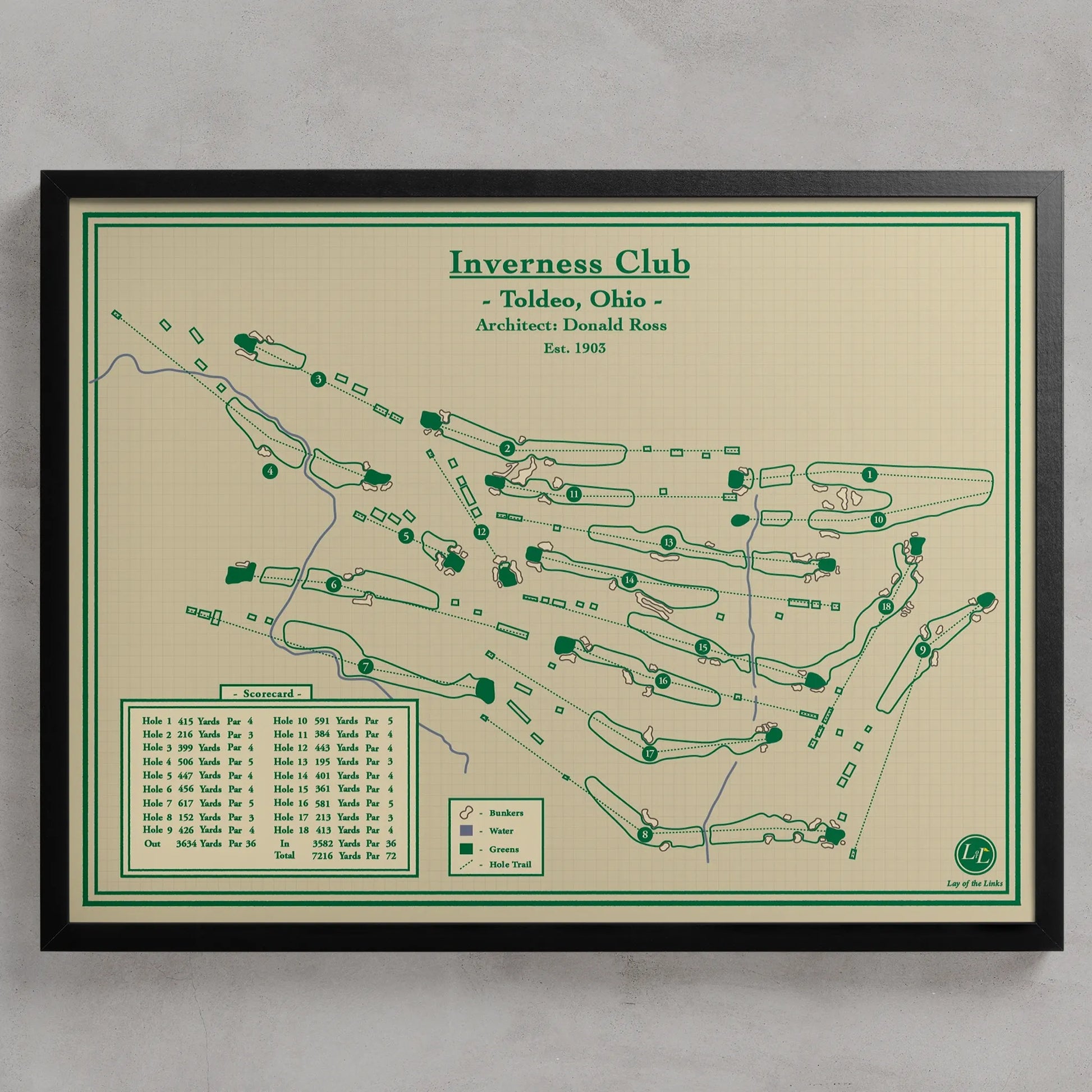 A framed golf course map print for Inverness Club, Toldeo, Ohio, featuring green course layouts and text on a cream background with a black frame, shown against a light gray wall.