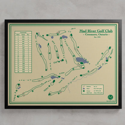 A framed Mad River Golf Club course map print hanging on a light gray wall. The print shows the golf course layout with green tees, fairways, greens, and a scoring table, in green and black text on a beige background, enclosed in a black frame.