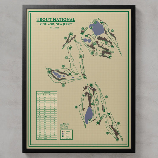A framed Trout National golf course map print featuring course layouts, a greens list table, and architectural notes, shown against a light gray textured wall.