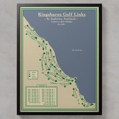 A framed golf course map print titled 'Kingsbarns Golf Links' showing the course layout in St Andrews, Scotland, with green tee marks on a beige and blue map background, enclosed in a black frame against a light gray wall.