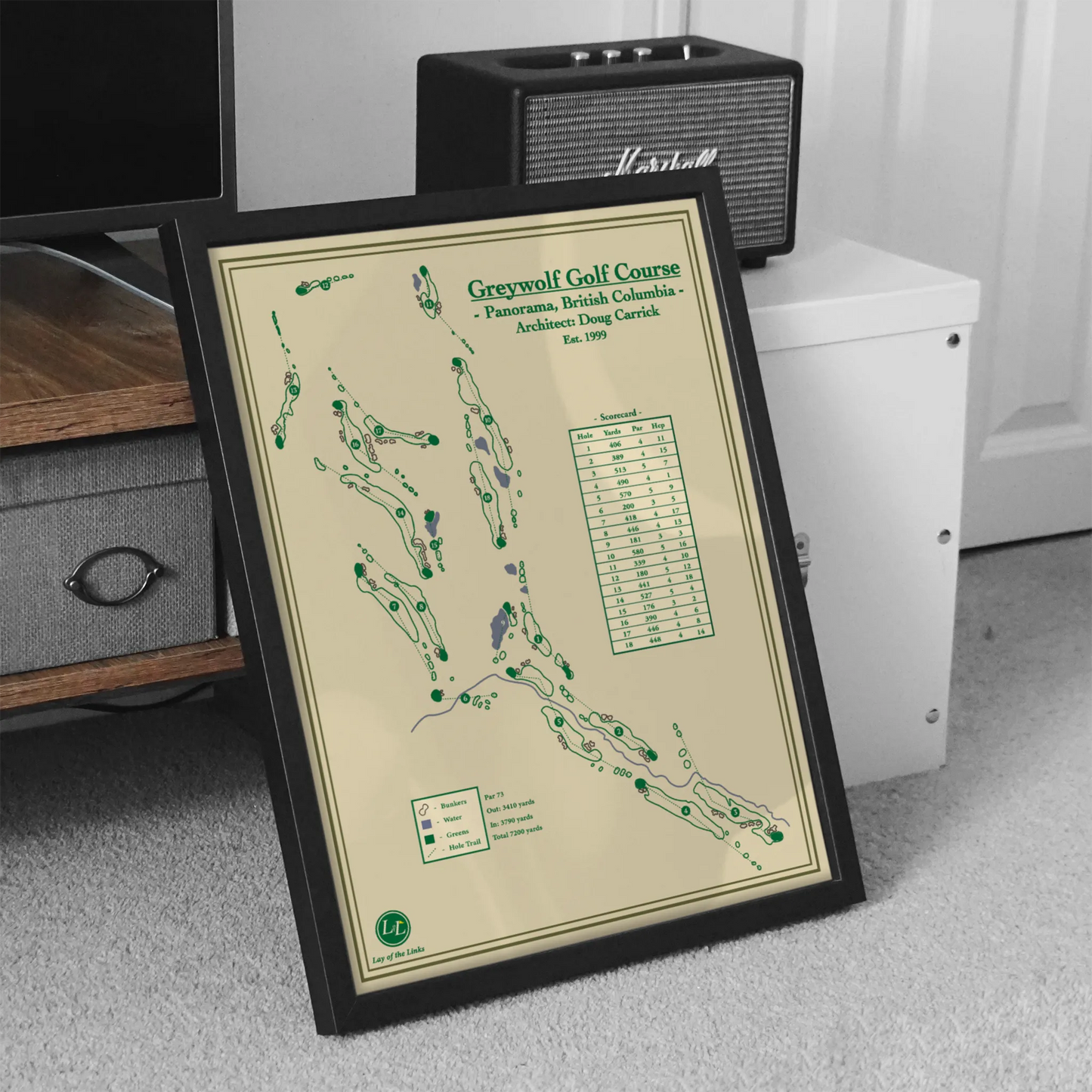 Framed greywolf golf course map on a carpeted floor with electronic equipment in the background